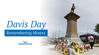 Graphic showing a monument next to the words Davis Day: Remembering Miners and the Province of Nova Scotia logo. 