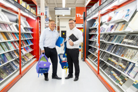 Education and Early Childhood Development Minister Brendan Maguire and Opportunities and Social Development Minister Scott Armstrong holding school supplies in a Staples store