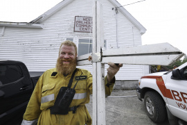 firefighter holds WWII memorial cross saved from fire