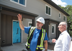 Housing Minister John White and Shawn Murphy, Site Manager, RCS Construction outside 