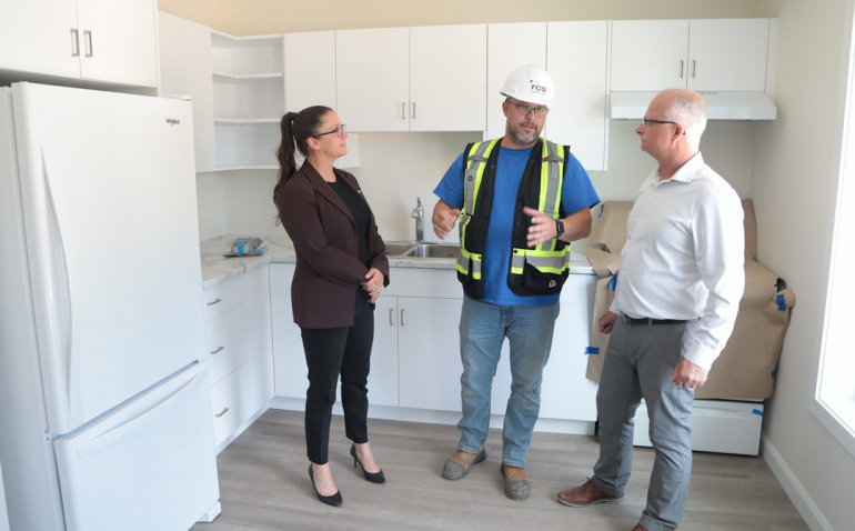 Kings South MLA Julie Vanexan; Shawn Murphy , Site Manager, RCS Construction, and Housing Minister John White in a townhouse
