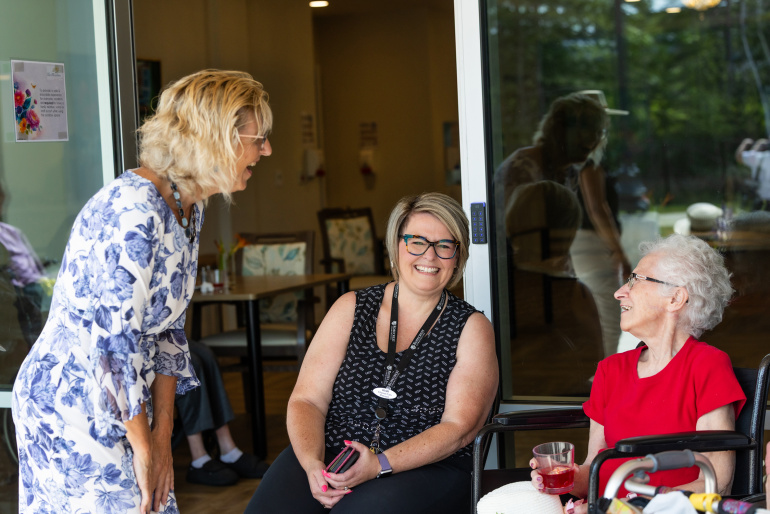 Seniors and Long-Term Care Minister Barbara Adams speaks with a staff member and resident of Rosecrest The Meadows 