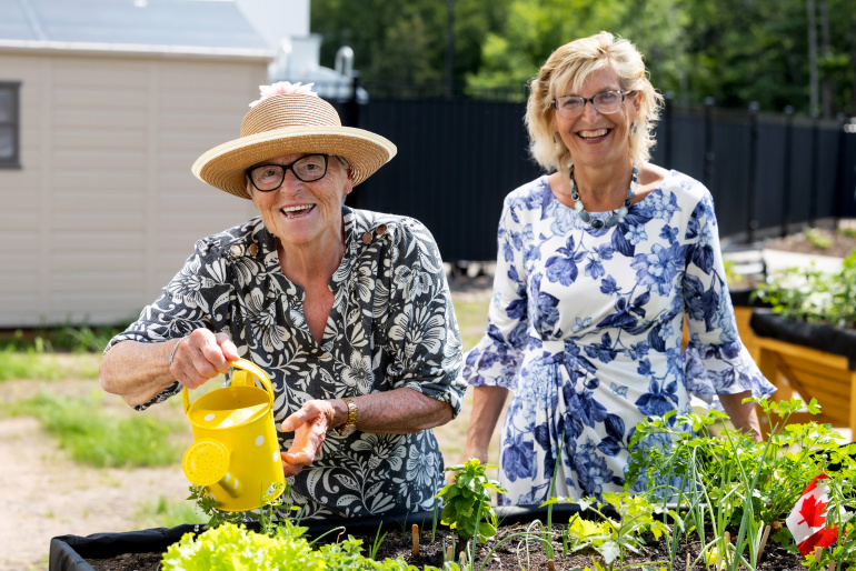 Seniors and Long-Term Care Minister Barbara Adams in a garden with a long-term care home resident
