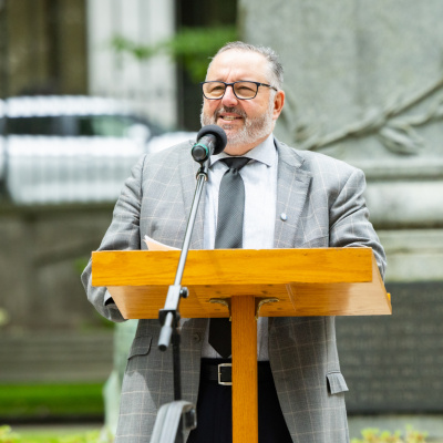 Public Works Minister Fred Tilley welcomes people to the grounds of Province House in Halifax for the 16th annual Pride flag raising.
