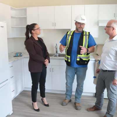 Kings South MLA Julie Vanexan; Shawn Murphy , Site Manager, RCS Construction, and Housing Minister John White in a townhouse