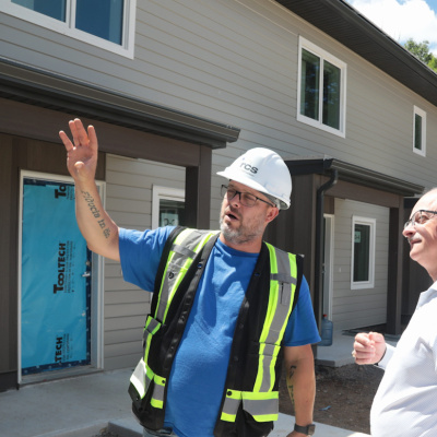 Housing Minister John White and Shawn Murphy, Site Manager, RCS Construction outside 