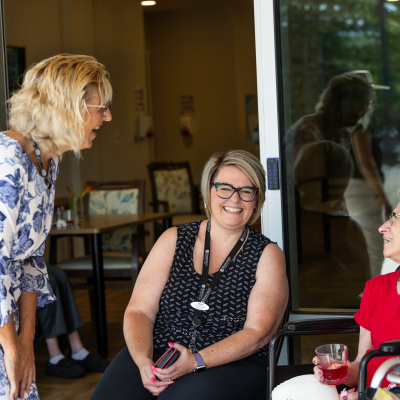Seniors and Long-Term Care Minister Barbara Adams speaks with a staff member and resident of Rosecrest The Meadows 