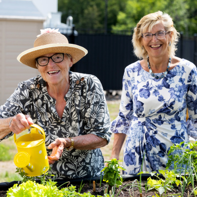 Seniors and Long-Term Care Minister Barbara Adams in a garden with a long-term care home resident